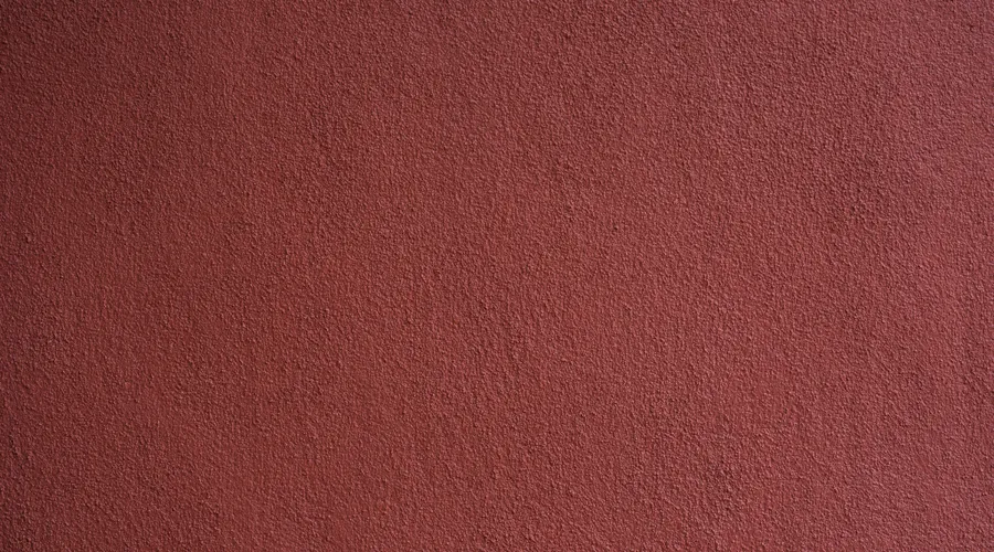 Best Exterior Paint for Sun Exposure and Climate - Simple background of uneven stucco pink wall surface of modern building in city