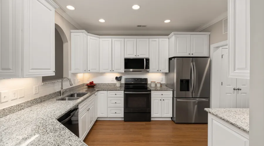 Head-to-Head: Best Surfaces and Rooms - Sleek kitchen with stainless steel appliances and granite countertops