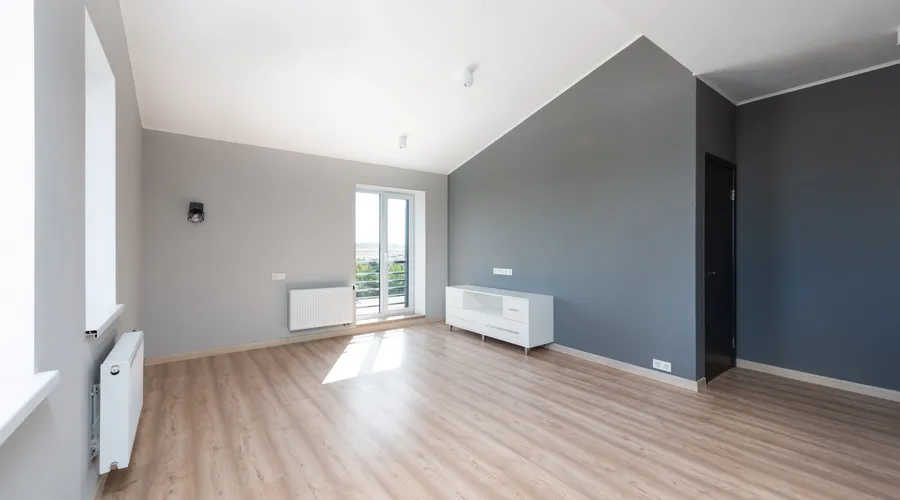 Head-to-Head: LRV and Depth - Wide-angle shot of a modern unfurnished apartment with wooden flooring and large windows