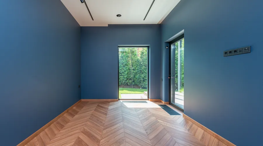 Head-to-Head: Undertones - Spacious room featuring blue walls