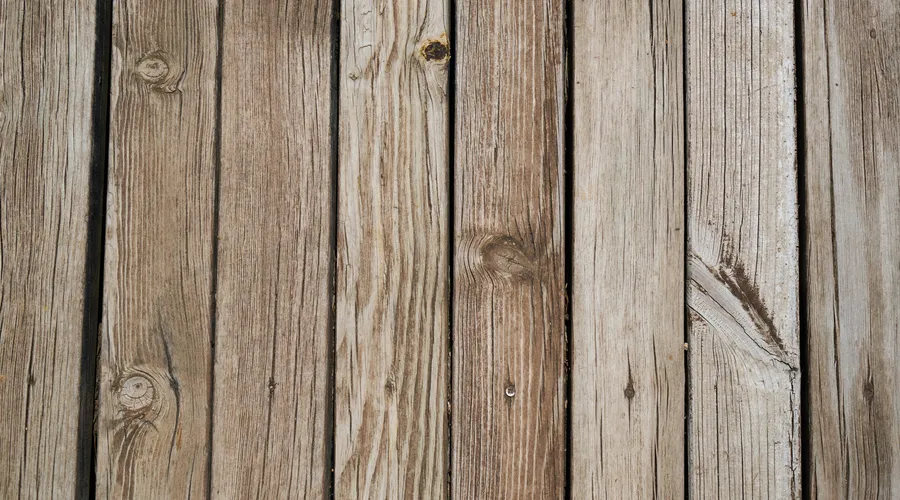 How to Choose the Right Sealer for Your Deck - A close-up view of rustic wooden planks showcasing natural wood texture and grain