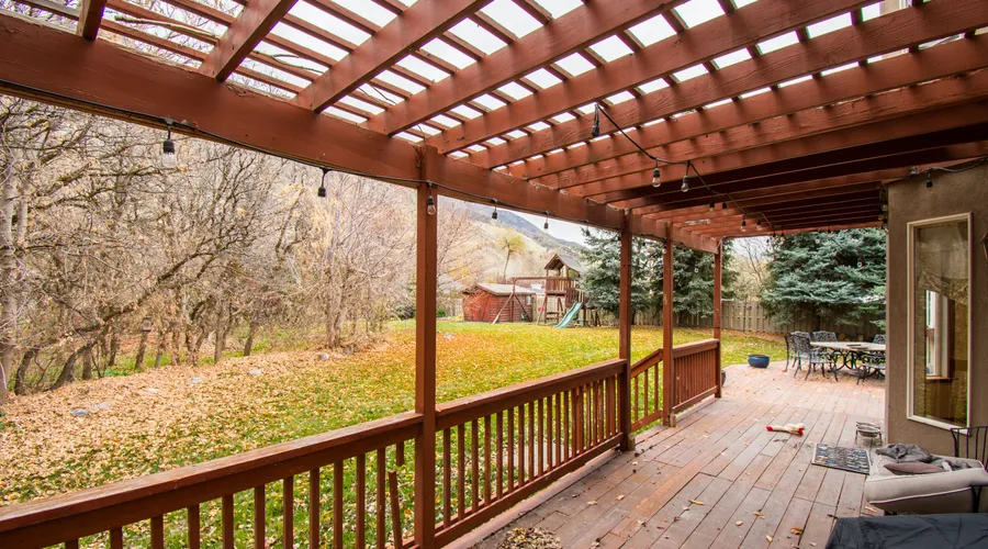Top 7 Deck Sealers for Full Sun - A beautiful wooden deck with autumn leaves