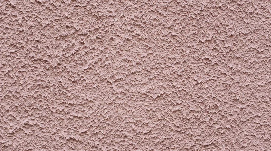 Flat (Matte) Masonry Finish - Simple background of uneven stucco pink wall surface of modern building in city
