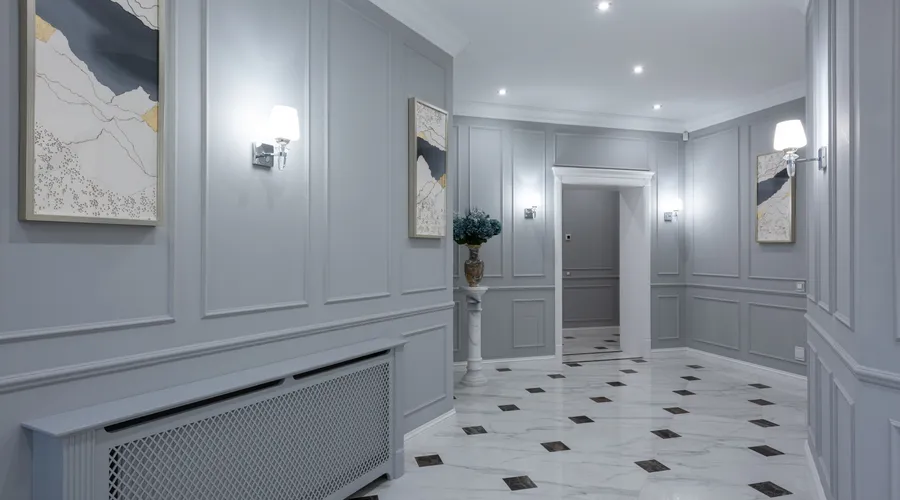 How to Choose the Right Floor Paint - Interior of corridor of contemporary villa with shiny tiled floor and gray walls decorated with paintings and lamps