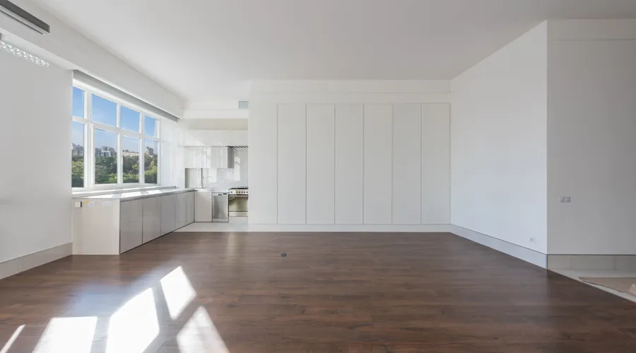 Top 4 Indoor Floor Paints Compared - Bright and spacious modern kitchen interior featuring wooden floors and white cabinetry