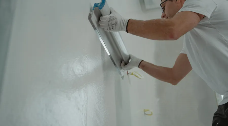 What Is Acrylic Latex Paint? - A man works on home renovation