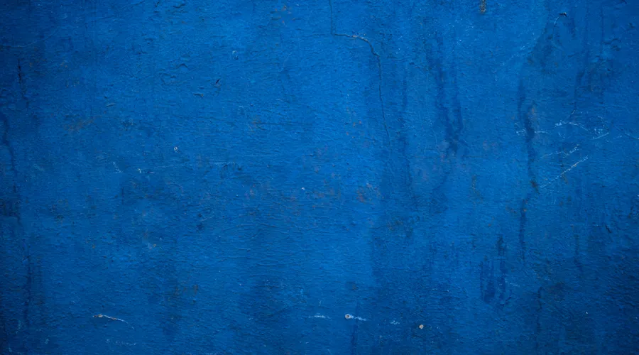 What Is Elastomeric Paint? - A vibrant blue wall with a textured surface