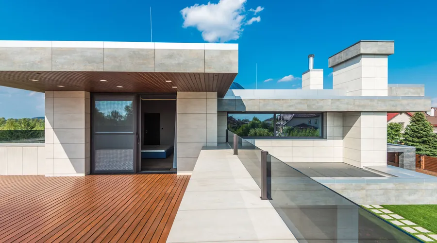 Clear vs Semi-Transparent vs Solid Sealers - Sleek modern terrace featuring wood decking and blue sky background