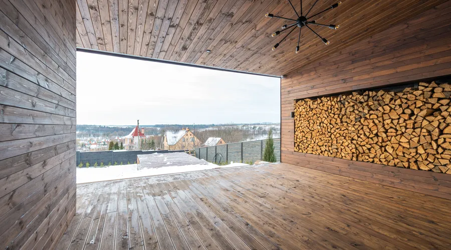 Quick Comparison - Spacious wooden interior with large firewood storage and outdoor view