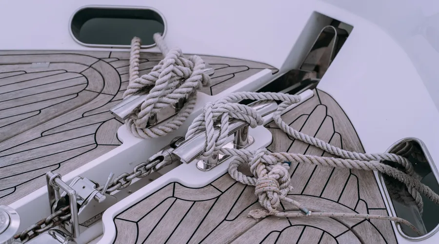 What Is a Transparent Deck Stain? - Detailed view of knotted ropes and chains on a boat deck