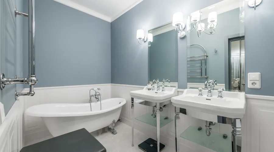 Which Should You Choose? - White bathtub placed near sinks under mirrors in light stylish bathroom in contemporary apartment