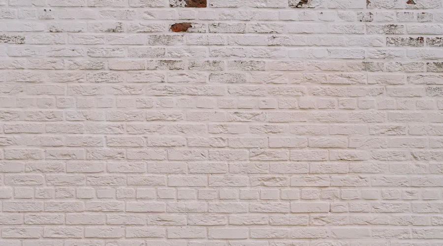 Head-to-Head: 5 Dimensions - A detailed view of a textured white brick wall